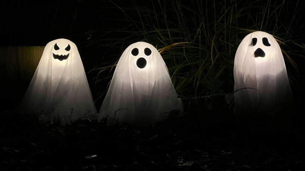Row of three ghosts against a black background